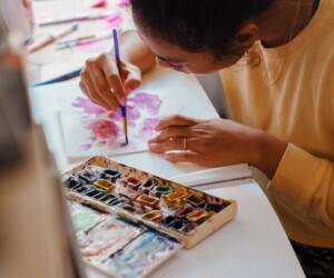 woman in yellow long sleeve shirt painting